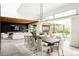 Contemporary living room and dining room with wood ceiling and a cozy fireplace, blending indoor and outdoor living at 140 S Glencoe St, Denver, CO 80246