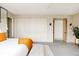 Bright main bedroom features a king size bed, bench seat, closet, and an en-suite bathroom at 140 S Glencoe St, Denver, CO 80246