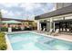 Stunning backyard featuring a sparkling pool, outdoor kitchen, spacious patio, and contemporary home design at 140 S Glencoe St, Denver, CO 80246