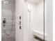 Modern shower featuring a rain shower head, handheld sprayer, sleek fixtures, and built-in bench at 140 S Glencoe St, Denver, CO 80246