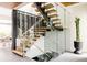 Unique staircase with glass panels, wood steps, and a view of the wine storage at 140 S Glencoe St, Denver, CO 80246