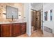 Luxurious bathroom with walk-in shower, vanity, and mosaic-tiled accent wall at 7821 Inverness Blvd, Englewood, CO 80112