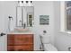 Bathroom featuring wood vanity, modern sink, and tile backsplash at 7821 Inverness Blvd, Englewood, CO 80112