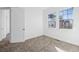 Bedroom with neutral carpet, white walls, and two large windows at 7821 Inverness Blvd, Englewood, CO 80112