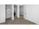Bright bedroom featuring neutral carpet, white walls, and closet with shelves at 7821 Inverness Blvd, Englewood, CO 80112