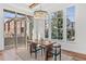 Bright dining room featuring large windows, chandelier, and modern table with seating at 7821 Inverness Blvd, Englewood, CO 80112