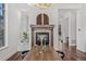 Elegant dining area showcasing a fireplace, chandelier, and hardwood floors at 7821 Inverness Blvd, Englewood, CO 80112