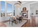 Bright dining room featuring large windows, fireplace, chandelier, and modern table with seating at 7821 Inverness Blvd, Englewood, CO 80112