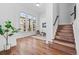 Entryway with hardwood floors, staircase, and bright light from large windows at 7821 Inverness Blvd, Englewood, CO 80112