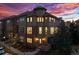 Stunning multi-story townhome with beautiful architectural details and an eye-catching sunset backdrop at 7821 Inverness Blvd, Englewood, CO 80112