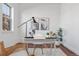 Cozy home office featuring hardwood floors, a modern desk, and natural light at 7821 Inverness Blvd, Englewood, CO 80112