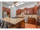Open kitchen with granite countertops, custom cabinets, stainless steel appliances, and a center island at 7821 Inverness Blvd, Englewood, CO 80112