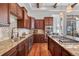 Well-appointed kitchen with custom cabinets, stainless steel appliances, and granite countertops at 7821 Inverness Blvd, Englewood, CO 80112