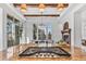 Spacious kitchen with island cooktop, wood beams, and a view of dining area and fireplace at 7821 Inverness Blvd, Englewood, CO 80112