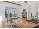 Bright kitchen featuring island cooktop, dining area, and fireplace at 7821 Inverness Blvd, Englewood, CO 80112