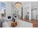 Bright living room with hardwood floors, contemporary furnishings, large windows and staircase at 7821 Inverness Blvd, Englewood, CO 80112