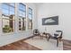 Bright living room with large windows, hardwood floors, and modern furnishings at 7821 Inverness Blvd, Englewood, CO 80112