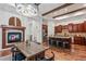Open concept living space with a fireplace, modern kitchen, and hardwood floors at 7821 Inverness Blvd, Englewood, CO 80112