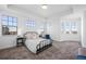 Spacious primary bedroom with abundant natural light, tray ceiling, and neutral carpet at 7821 Inverness Blvd, Englewood, CO 80112
