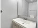 Modern bathroom featuring a sleek white vanity, a mirror, and a neutral color scheme at 453 Arden Cir, Highlands Ranch, CO 80126