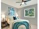 Comfortable bedroom featuring a ceiling fan and a large window providing natural light and views at 453 Arden Cir, Highlands Ranch, CO 80126