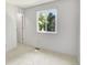 Bright bedroom with a window and a door leading to a hallway, offering natural light and functionality at 453 Arden Cir, Highlands Ranch, CO 80126
