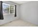 Simple bedroom with a large window, blinds, and carpeted flooring providing natural light at 453 Arden Cir, Highlands Ranch, CO 80126