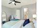 Relaxing bedroom with a chair, ceiling fan, closet, and a view into an attached bathroom at 453 Arden Cir, Highlands Ranch, CO 80126