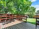 Wooden deck with red wood railing overlooking manicured backyard lawn at 453 Arden Cir, Highlands Ranch, CO 80126