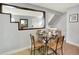 Cozy dining area with a glass table set for four, modern decor, and reflective mirror accents at 453 Arden Cir, Highlands Ranch, CO 80126