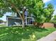 Inviting two-story home featuring mature trees and a neatly landscaped front yard at 453 Arden Cir, Highlands Ranch, CO 80126
