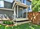 Welcoming front porch with gray pillars, flower beds, and a well-manicured lawn at 453 Arden Cir, Highlands Ranch, CO 80126