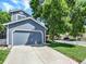 Home featuring a gray garage with concrete driveway and landscaped lawn at 453 Arden Cir, Highlands Ranch, CO 80126
