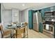 Well-equipped kitchen with stainless steel appliances, teal cabinets, and dining space at 453 Arden Cir, Highlands Ranch, CO 80126
