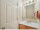 Cozy half-bathroom featuring a wood cabinet sink and bright lighting at 725 High St, Erie, CO 80516