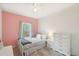 Comfortable bedroom with a full-sized bed, dresser, plush rug, and bright window at 725 High St, Erie, CO 80516