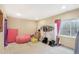 Bedroom space with a window, clothes rack, storage, and a pink beanbag chair at 725 High St, Erie, CO 80516