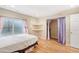 Bedroom featuring a bed, built-in shelves, and closet with privacy curtains at 725 High St, Erie, CO 80516