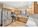 Well-equipped kitchen with stainless steel appliances, wood cabinets, and hardwood floors at 725 High St, Erie, CO 80516