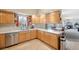Spacious kitchen area featuring ample counter space and wood cabinetry, with modern appliances at 725 High St, Erie, CO 80516