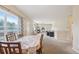 Bright, open-concept living and dining room with large windows and access to outdoor deck at 725 High St, Erie, CO 80516