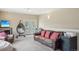 Relaxing living room featuring a comfortable brown leather sofa and an elegant hanging chair at 725 High St, Erie, CO 80516