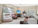 Bright living room with a fireplace, comfortable seating, and a large window with stylish curtains at 725 High St, Erie, CO 80516