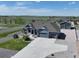 Stunning aerial view of a blue home featuring a long driveway and a detached garage at 31353 E 163Rd Ave, Hudson, CO 80642