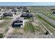 A birds eye view showcasing a house, outbuilding, green grass and white fencing outlining the property at 31353 E 163Rd Ave, Hudson, CO 80642