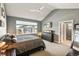 This primary bedroom features neutral walls, carpet flooring, and a large window for plenty of natural light at 31353 E 163Rd Ave, Hudson, CO 80642
