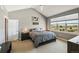 Cozy bedroom with a large window, neutral walls, carpet flooring, and a comfortable bed at 31353 E 163Rd Ave, Hudson, CO 80642