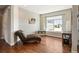 Cozy bedroom with hardwood floors, a window view, and comfortable seating at 31353 E 163Rd Ave, Hudson, CO 80642