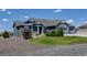 Attractive blue home boasts a well-manicured lawn and gravel landscaping at 31353 E 163Rd Ave, Hudson, CO 80642
