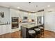This kitchen features an island with granite countertops, stainless steel appliances, and hardwood floors at 31353 E 163Rd Ave, Hudson, CO 80642